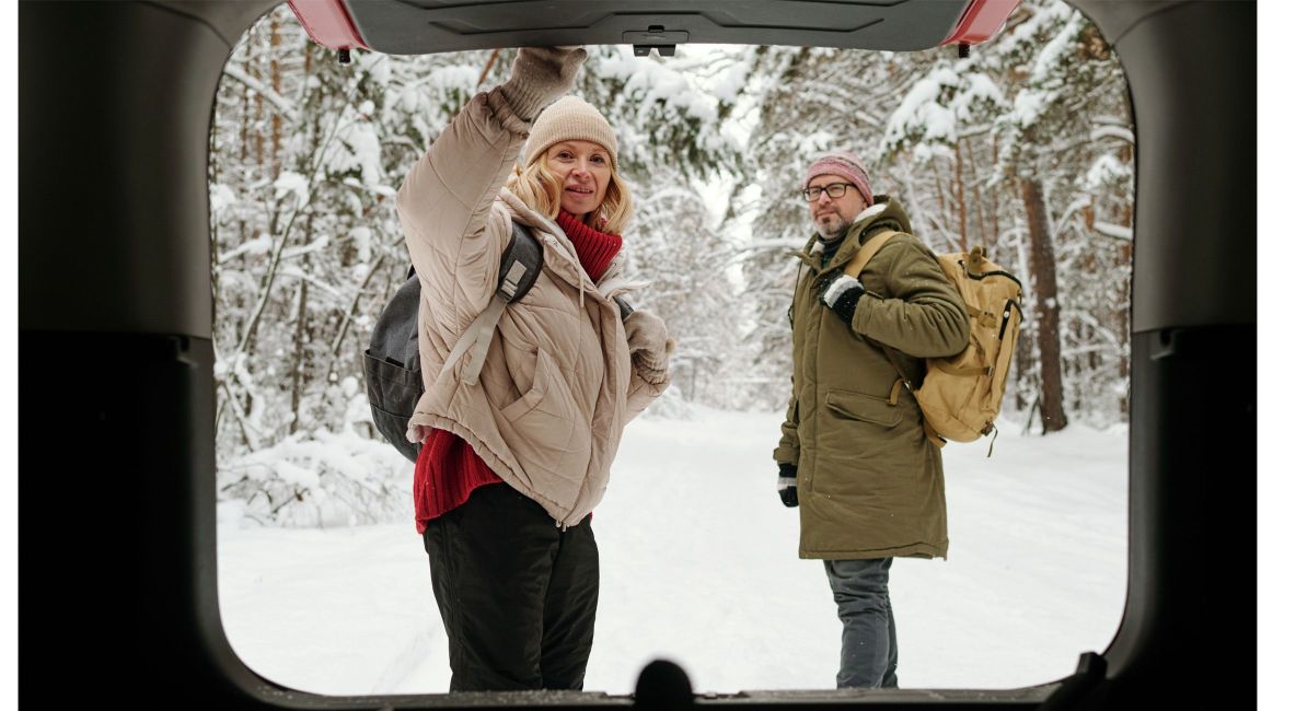 Woman and Man Unloading Car in Winter - Post Image